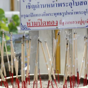 Incense sticks are burning, creating a fragrant smoke Incense sticks are burning, creating a fragrant smoke