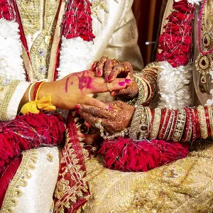 Indian bride passing wedding ring on her groom's finger on her wedding ceremony