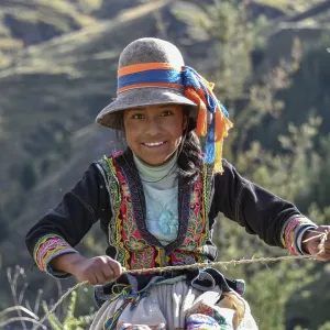 Indio girl with hat smiles and weaves Pacha grass Indio girl with hat smiles and weaves Pacha grass
