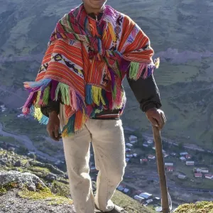 Indio mountain guide with hat and poncho in the Andes