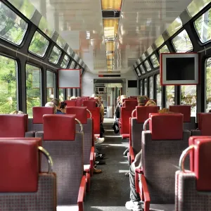 Interior of a train with red seats and large windows Interior of a train with red seats and large windows