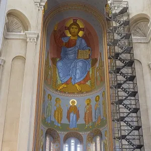 Interior view of a church with tall domes and magnificent frescoed icon paintings
