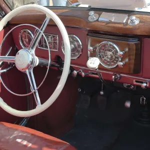 Interior view of a classic car with wooden details and retro dashboard