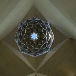 Interior view of a dome with intricate geometric patterns and a skylight