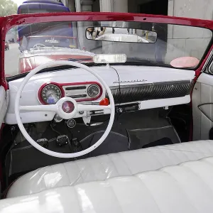 Interior of a vintage convertible with white leather and retro control panel Interior of a vintage convertible with white leather and retro control panel