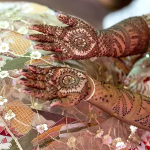 Intricate henna designs adorn the hands of a bride