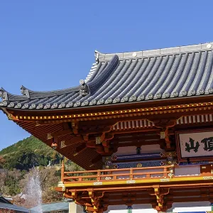 Japanese temple with magnificent roof against clear sky