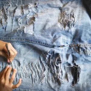 Jeans being torn, holes in the trousers