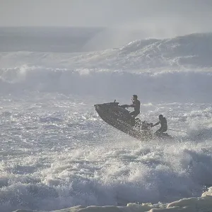 Jet ski jumping over a wave in the stormy Atlantic Ocean Jet ski jumping over a wave in the stormy Atlantic Ocean