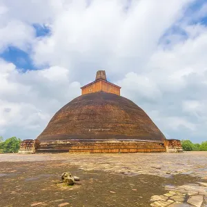 Jetavanaramaya Dagoba or stupa with damaged spire seen centered from platform corner in the ancient capitol of Jetavanaramaya Dagoba or stupa with damaged spire seen centered from platform corner in the ancient capitol of
