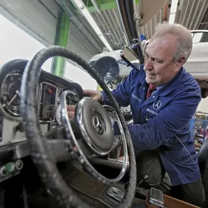 Juergen Kaltschmitt working on his vintage Mercedes Benz convertible SL 250 Pagoda