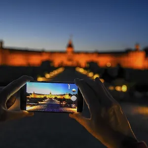 Karlsruhe castle at dusk in the display of a mobile phone