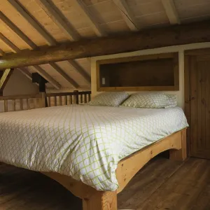 King size bed with pine wood frame in sparsely furnished Zen stmaster bedroom on mezzanine inside Scandinavian hybrid King size bed with pine wood frame in sparsely furnished Zen stmaster bedroom on mezzanine inside Scandinavian hybrid