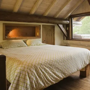 King size bed with wood frame in sparsely furnished Zen style master bedroom on mezzanine inside Scandinavian hybrid King size bed with wood frame in sparsely furnished Zen style master bedroom on mezzanine inside Scandinavian hybrid