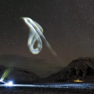Kite illuminated by a head lamp at night