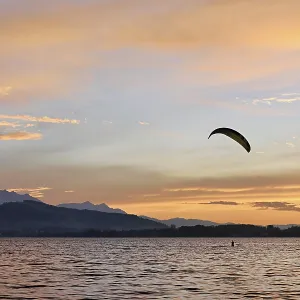 Kitesurfer on Lake Zug at sunset