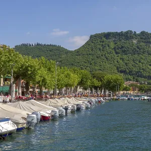 Lake promenade, harbour and the Rocca di Garda mountain in Garda Lake promenade, harbour and the Rocca di Garda mountain in Garda