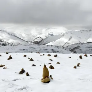 Landscape, cairns in the snow, mountains