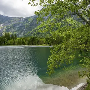 Landscape of Lake Offensee after rain when the sun comes through the clouds in spring