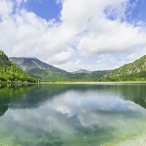Landscape of Lake Offensee after rain when the sun comes through the clouds in spring Landscape of Lake Offensee after rain when the sun comes through the clouds in spring