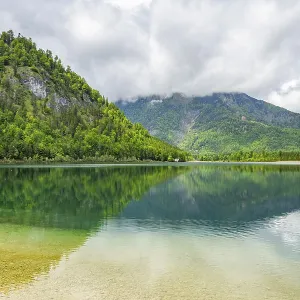 Landscape of Lake Offensee after rain when the sun comes through the clouds in spring