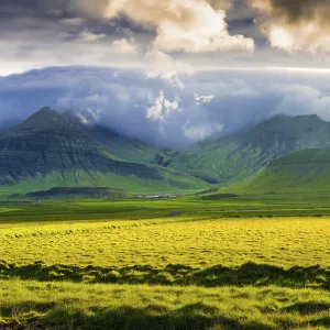 Landscape with meadow and mountains in the evening light Landscape with meadow and mountains in the evening light