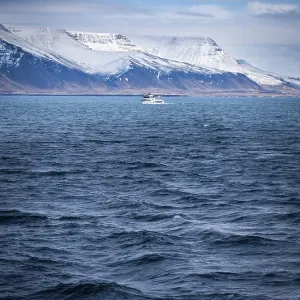 A large body of water with mountains in the background A large body of water with mountains in the background