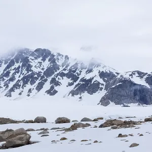 Large boulders in the snow, mountain range