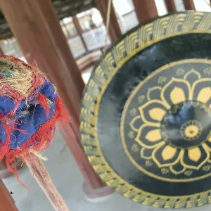 Large decorated gong with a mallet in a Buddhist monastery The Shwezigon Pagoda or Shwezigon Paya