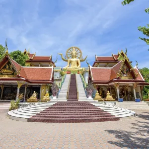 Large gold buddha statue in a sitting position under the blue sky at Big Buddha Temple is a famous tourist destination