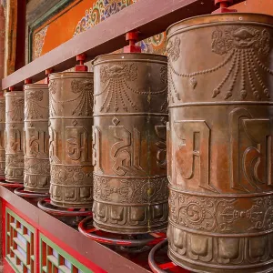 Large permanently installed prayer wheels in a temple of the Kumbum Monastery in Xining