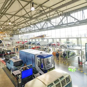 Large room with vintage and modern cars Large room with vintage and modern cars