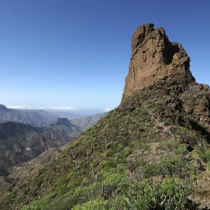 Large, steep rock under blue sky Large, steep rock under blue sky