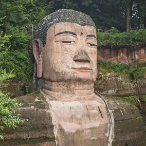 Leshan, China - July 2019 : The close up of the head and torso of the Giant Leshan Buddha Leshan, China - July 2019 : The close up of the head and torso of the Giant Leshan Buddha