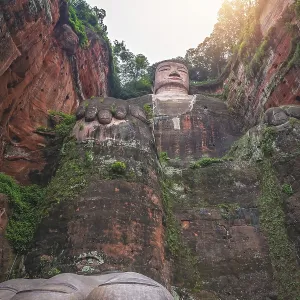 Leshan, China - July 2019 : The close up of the head and torso of the Giant Leshan Buddha Leshan, China - July 2019 : The close up of the head and torso of the Giant Leshan Buddha