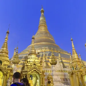 Light illuminates majestic stupas at night in a temple complex