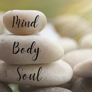 Light shining on zen stones with words Mind
