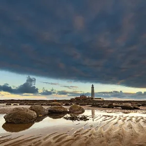 Lighthouse, St. Mary's Lighthouse at low tide with clouds at sunrise