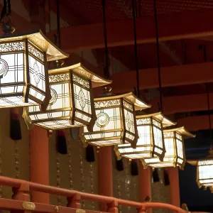 Line of decorative lamps lighting in the temple Fushimi Inari Shrine