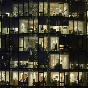 Lit offices at night, glass facade of Main Tower