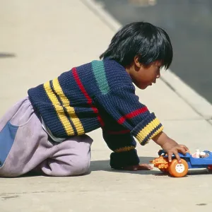 Little boy playing with toy car