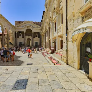 Lively historic square with architectural details and visitors
