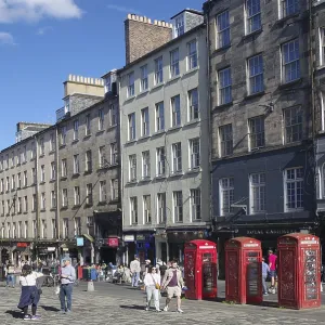 Lively street view with historic buildings and striking red telephone boxes in daylight Lively street view with historic buildings and striking red telephone boxes in daylight