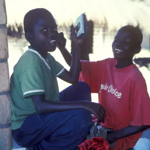 Two local boys with Walkman in a village near Kande Two local boys with Walkman in a village near Kande