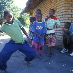 Local children dance happily to music in a village near Kande Local children dance happily to music in a village near Kande