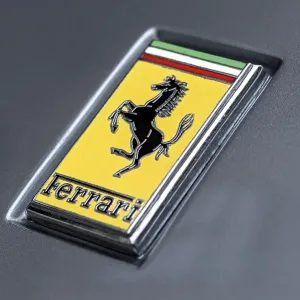 Logo of the Ferrari car brand on a vintage sports car Ferrari 275 GTB4