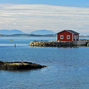 Lonely red wooden house at a bay near Bud Lonely red wooden house at a bay near Bud