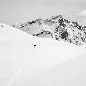 Two lonely ski tourers in a snowy mountain landscape Two lonely ski tourers in a snowy mountain landscape