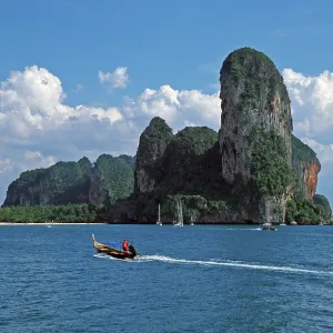 Longtail boat, rocks in the sea Longtail boat, rocks in the sea