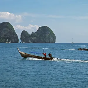 Longtail boats, rocks in the sea Longtail boats, rocks in the sea